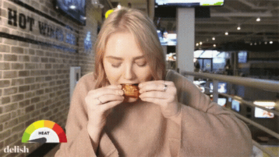 Woman Eating Hot Wing GIF