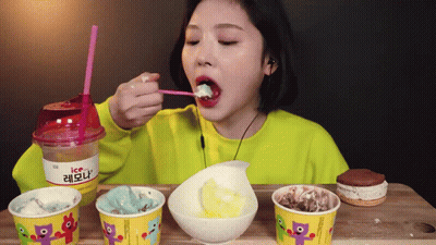 Woman Eating Ice Cream From Cup With Straw GIF