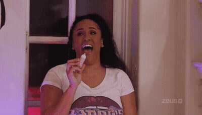 Woman Eating Ice Cream With Zeus Shirt GIF