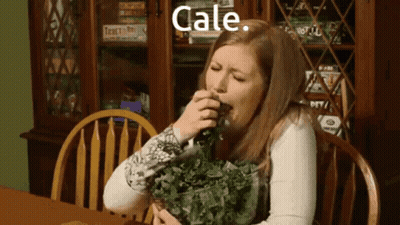Woman Eating Kale In Front Of Bookcase GIF