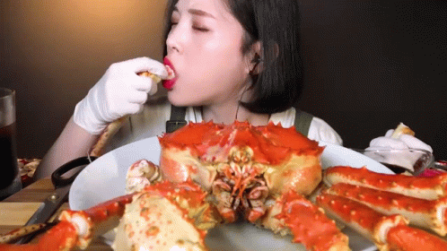 Woman Eating Large Crab GIF