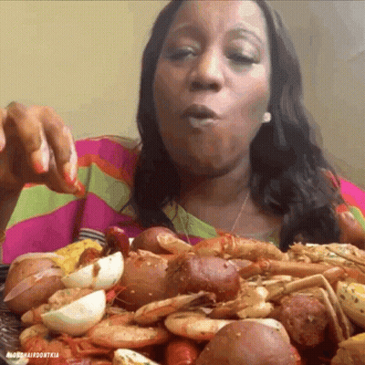 Woman Eating Lots Of Food From Mardi Gras Don Tia Plate GIF