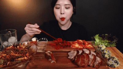 Woman Eating Meat And Vegetables With Chopsticks GIF