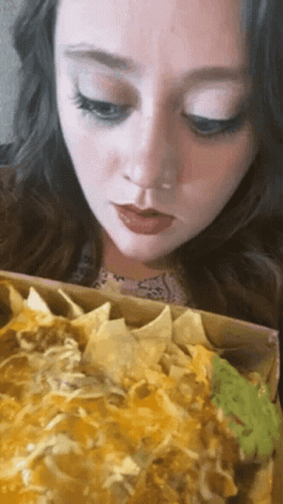 Woman Eating Nachos With Guacamole GIF