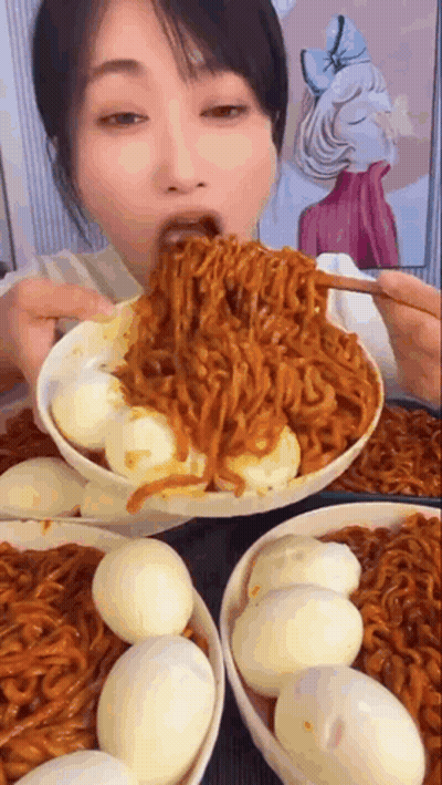 Woman Eating Noodles And Eggs From Bowl GIF