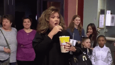 Woman Eating Popcorn In Theater GIF