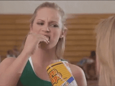 Woman Eating Popcorn While Another Looks On GIF
