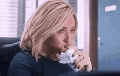 Woman Eating Sandwich At Computer GIF