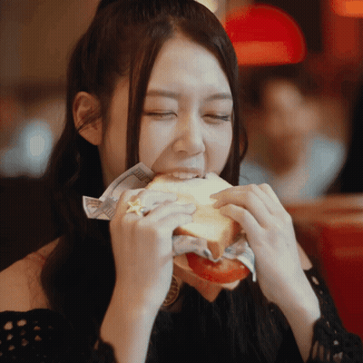 Woman Eating Sandwich With Star On Finger GIF