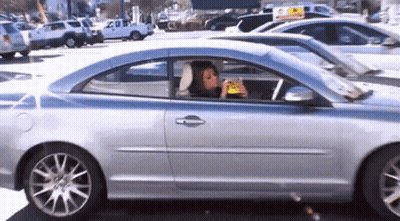 Woman Eating Snack In Car GIF