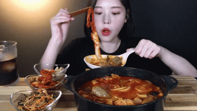 Woman Eating Stew With Spoon And Chopsticks GIF