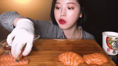 Woman Eating Sushi Next To Ramen Soup GIF