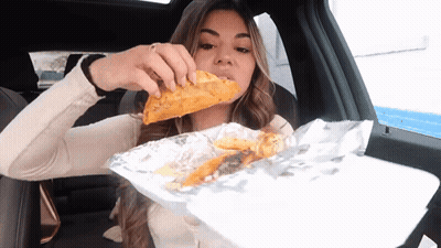 Woman Eating Taco In Car GIF