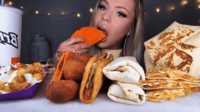 Woman Eating Taco Next To Taco Bell Cup GIF