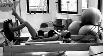 Woman Exercising On Pilates Machine Black And White GIF