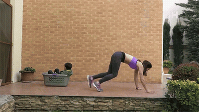 Woman Exercising With Child In Laundry Basket GIF
