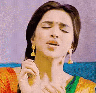 Woman Eyes Closed In Red And Green Dress GIF