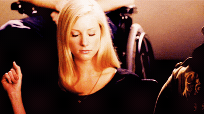 Woman Eyes Closed, Man In Wheelchair Behind GIF
