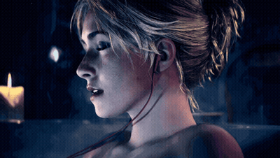 Woman Face Close Up With Earbuds GIF