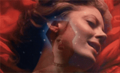 Woman Face Surrounded By Red Flowers GIF