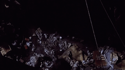 Woman Falling Off Brick Wall At Night GIF