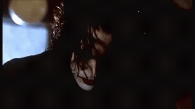 Woman Falling Off Brick Wall At Night GIF