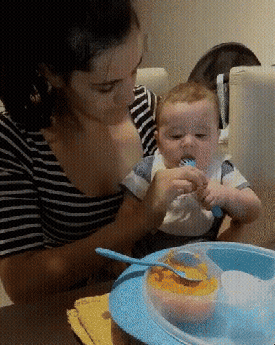 Woman Feeding Baby With Fork And Spoon GIF