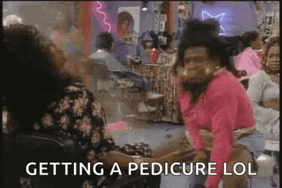 Woman Feet With Red Toenails And Toe Separators GIF
