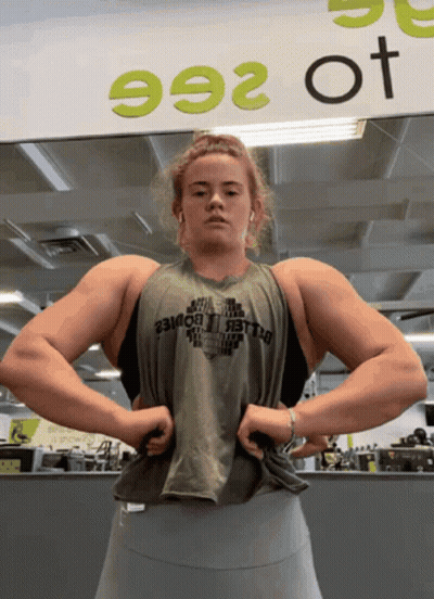 Woman Flexing Muscles At Sign 992 GIF