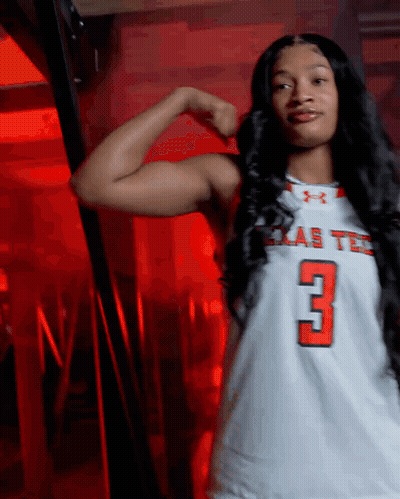 Woman Flexing Muscles In Texas Tech Jersey GIF