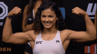 Woman Flexing Muscles In UFC Tank Top GIF
