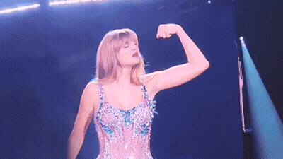 Woman Flexing Muscles On Stage GIF