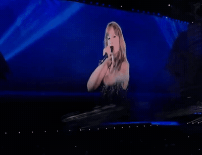 Woman Flexing Muscles On Stage GIF