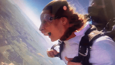 Woman Flying With Parachute GIF