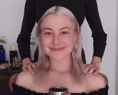 Woman Getting Massage From Another Holding Cup GIF