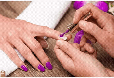Woman Getting Nails Painted Purple At Salon GIF