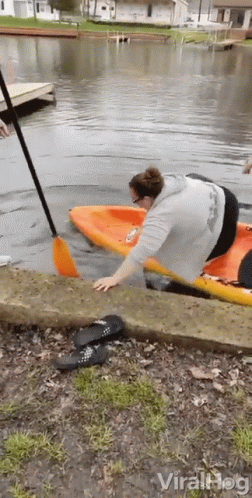 Woman Getting Out Of Kayak In Water GIF