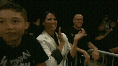 Woman Giving Peace Sign In Crowd GIF