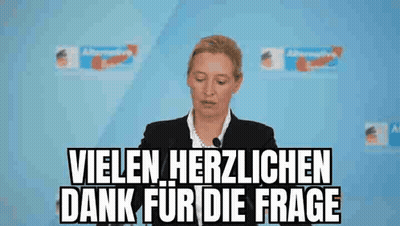 Woman Giving Speech In Front Of Vielen Herzlichen Dank For Die Frage Sign GIF