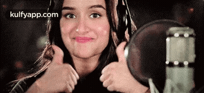 Woman Giving Thumbs Up At Microphone GIF