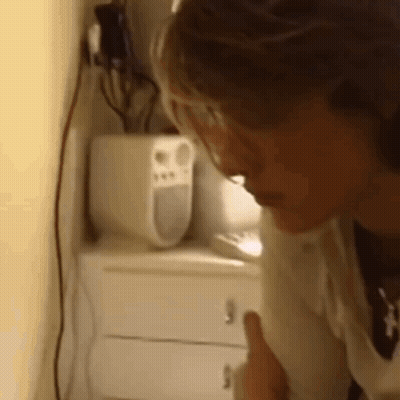 Woman Giving Thumbs Up Beside Speaker GIF