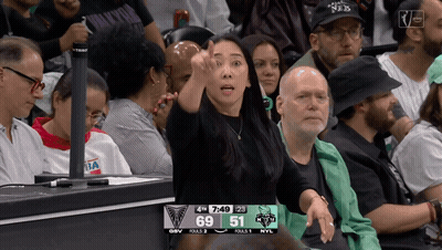 Woman Giving Thumbs Up In Front Of Scoreboard 69 And 51 GIF