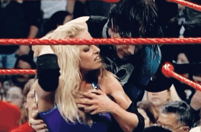 Woman Held By Man In Wrestling Ring GIF