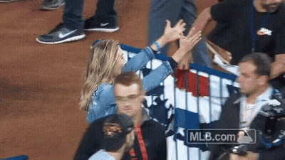 Woman High Fives Man Behind Fence With MLB.com GIF