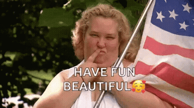 Woman Holding American Flag With Finger In Nose GIF