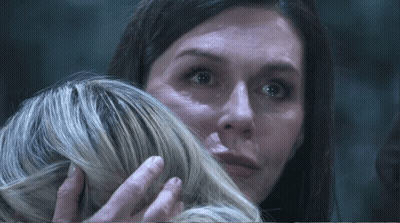 Woman Holding Another Woman's Hair Looking At Camera GIF