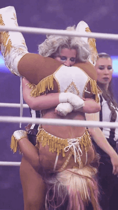 Woman Holding Another Woman Upside Down In Wrestling Ring GIF