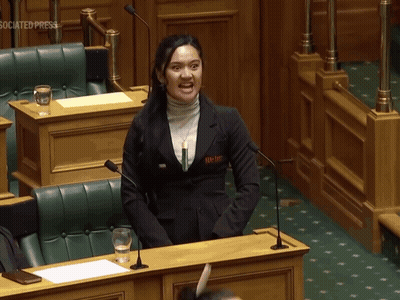 Woman Holding Associated Press Paper At Microphone GIF