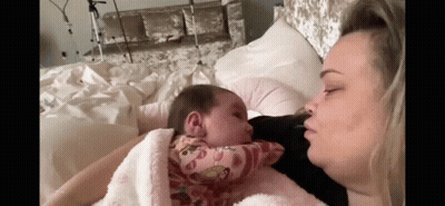 Woman Holding Baby And Kissing GIF