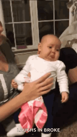Woman Holding Baby Crying And Laughing GIF